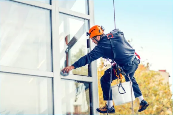 Technician on ladder providing window cleaning Philadelphia services