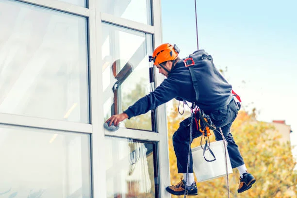 Technician on ladder providing window cleaning Philadelphia services